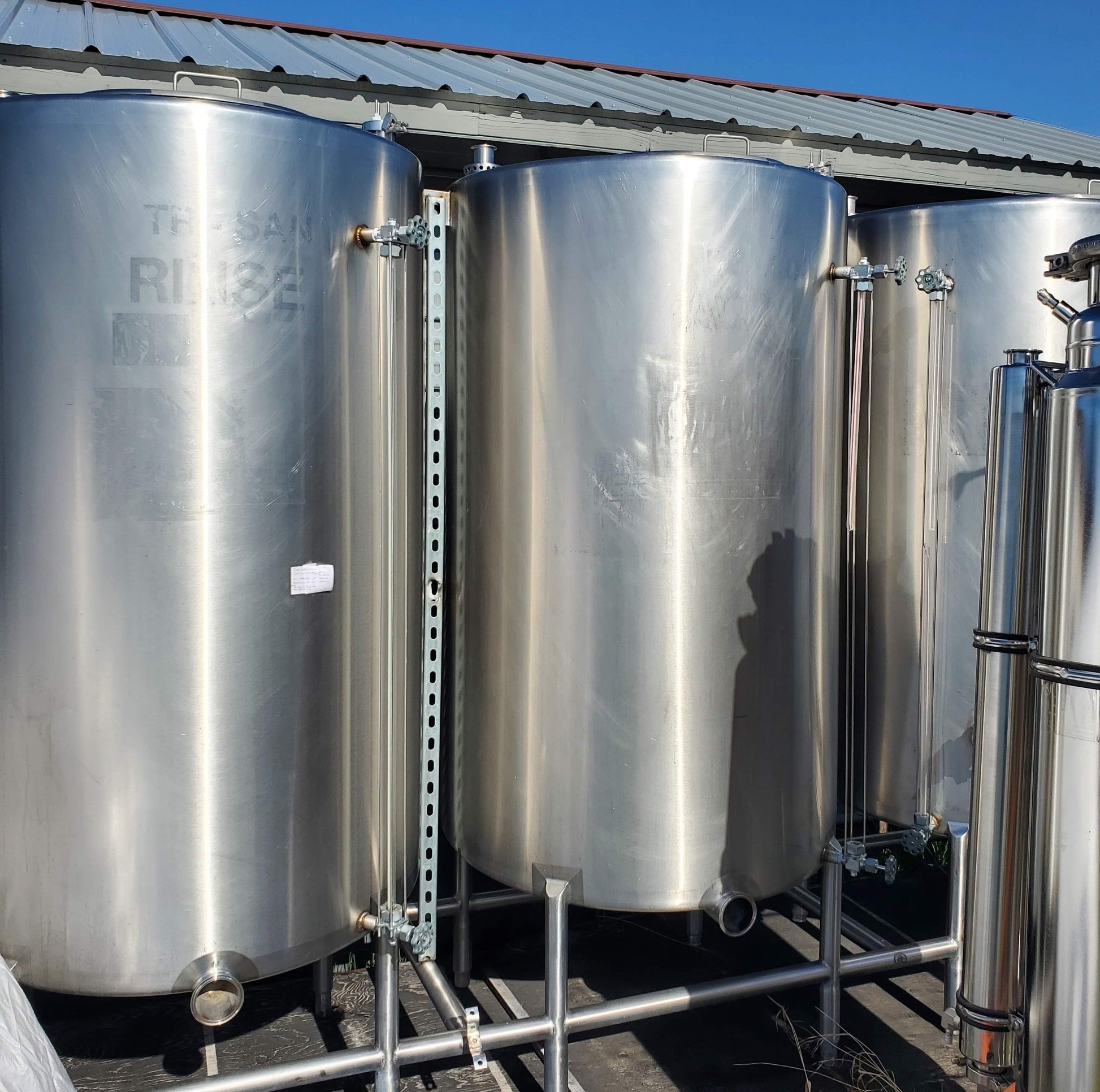 250 gallon sanitary stainless steel vertical storage tanks with 3-inch bottom ports and sight glass rails
